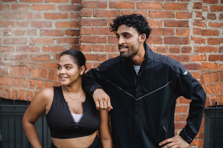 Man And Woman Taking Break In Exercise