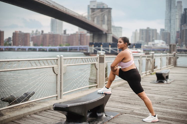 Woman Stretching On Pier