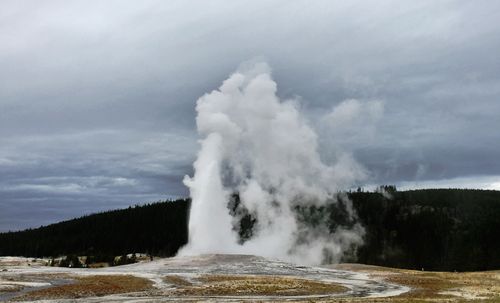 Free Spectacular geyser eruption in Yellowstone National Park, showcasing nature's power with steaming hot springs. Stock Photo