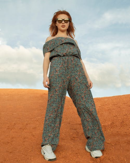 Woman Wearing Jumpsuit Standing on Brown Sand