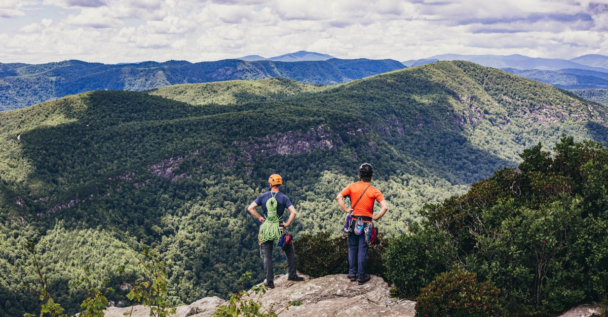 Two climbers overlook the lush Linville Gorge, capturing the essence of adventure and nature.