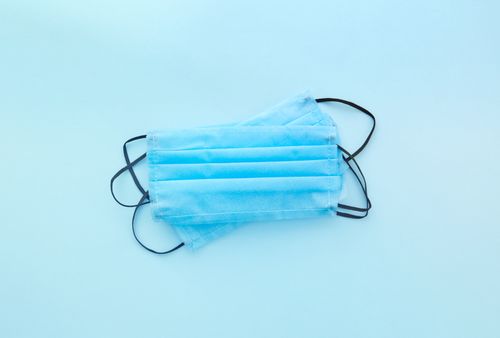 Free Close-up of blue disposable face masks on a light background with copy space. Stock Photo