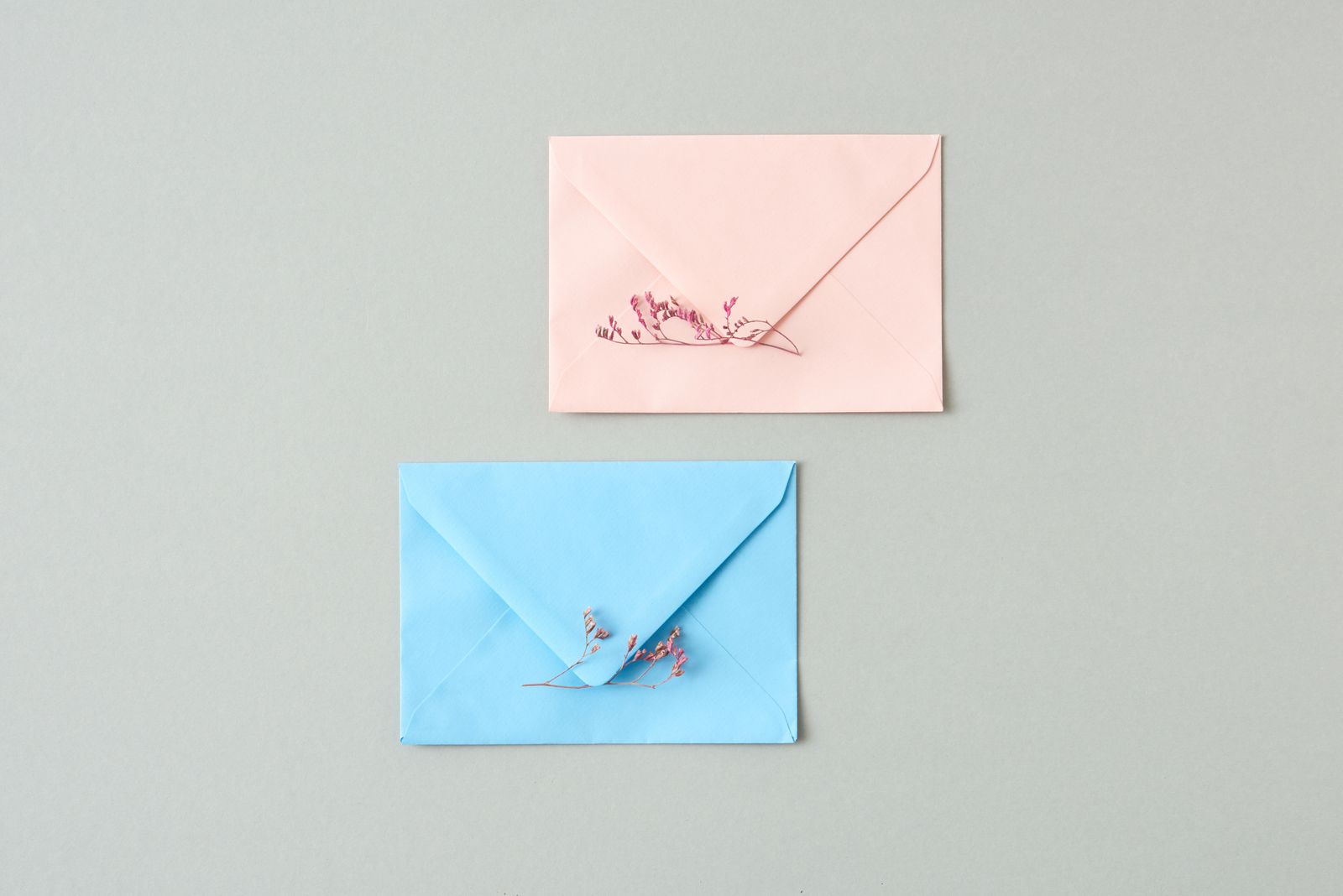 Pastel envelopes with delicate flowers for a simple invitation route.