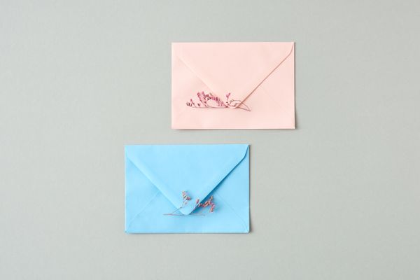 Pastel envelopes trimmed with dried flowers — photo by DS stories on Pexels