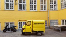Yellow Tree Wheeler Van Parked Beside a Yellow Building