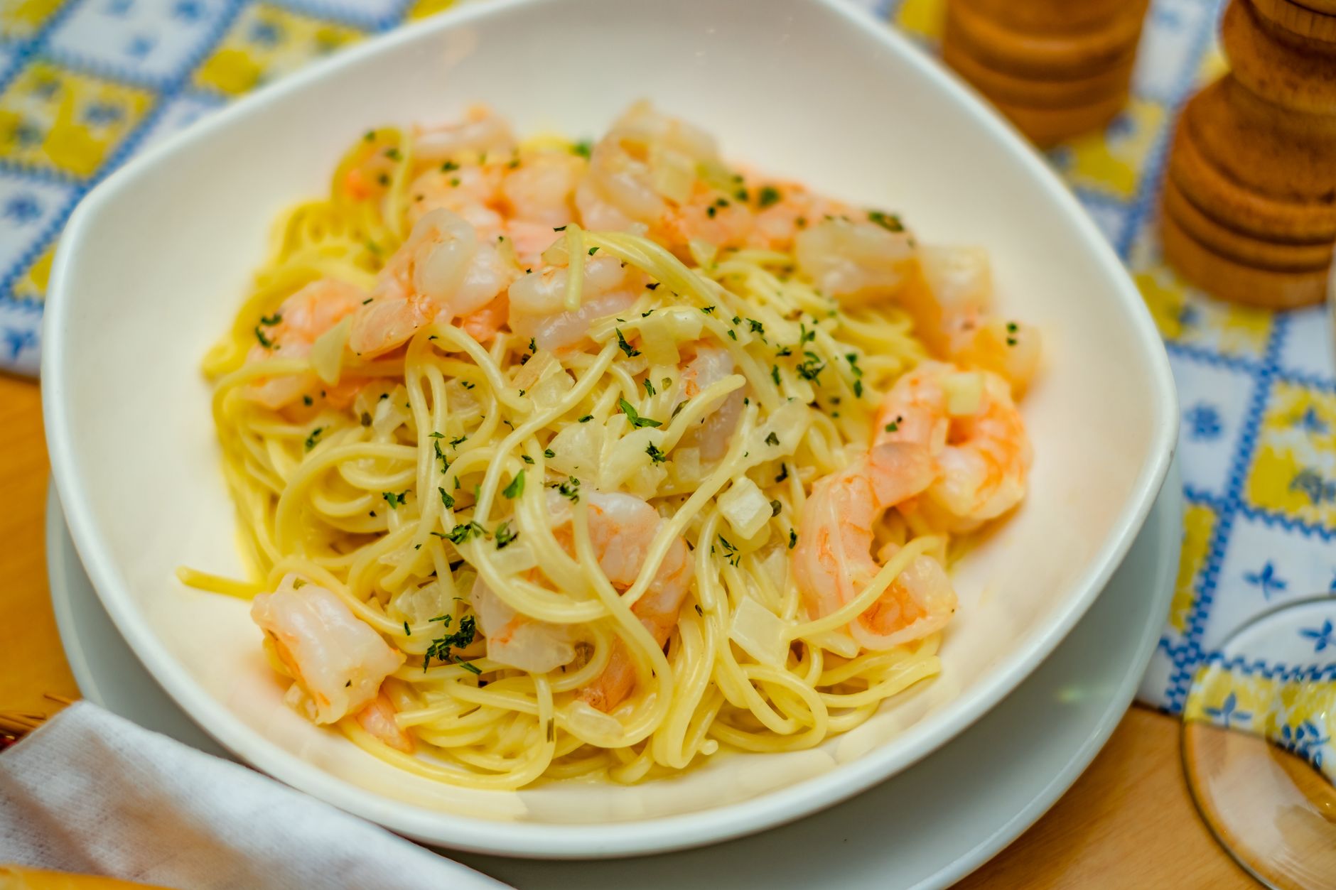 Plated Tasso shrimp cream pasta garnished with green onions
