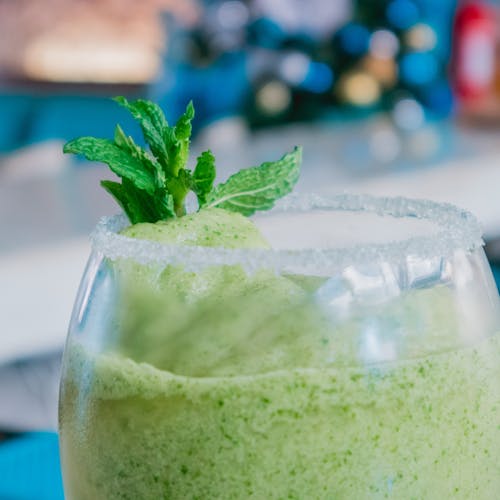 Free Green Smoothie in a Wine Glass with Mint Leaves on Top Stock Photo