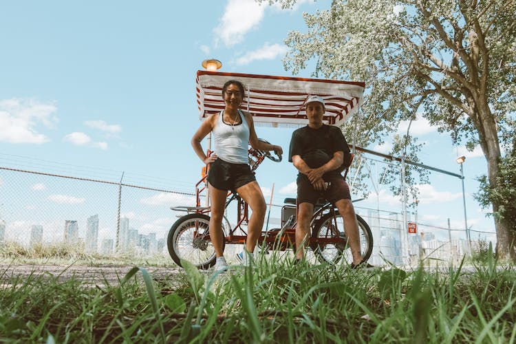 Young Couple Near Golf Car In Park