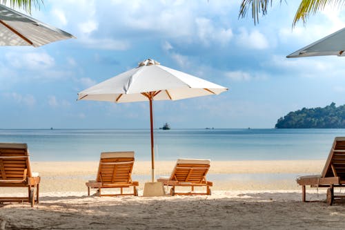 Deckchairs and umbrellas on sandy beach