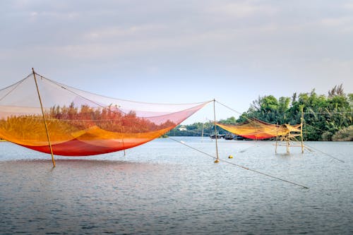Fishing nets over water at daytime