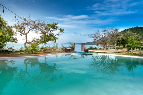 Swimming pool in yard of resort hotel on seashore