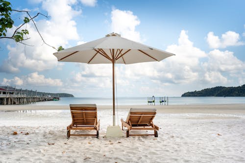 Loungers and parasol on seashore