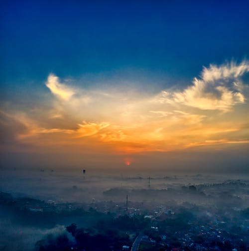 Free Bird's Eye View of a Golden Hour Sky Over the Foggy Landscape Stock Photo