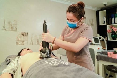 Woman Making Vacuum Massage to Client in Salon