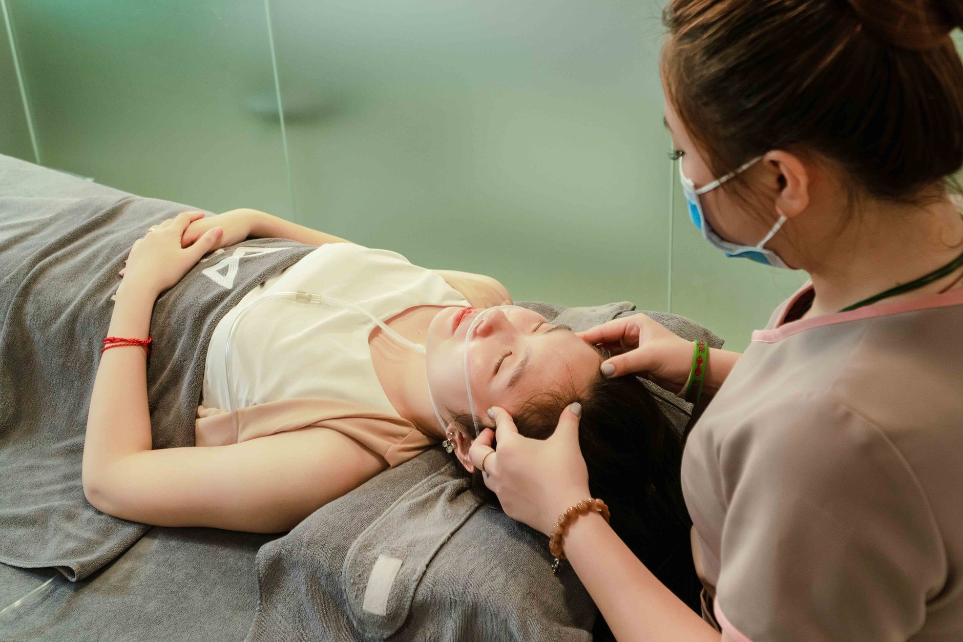 A woman receiving a relaxing facial massage at a spa in Hanoi, Vietnam.