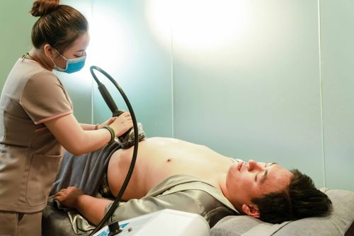 Free A healthcare professional performs an ultrasound on a patient in a medical clinic. Stock Photo