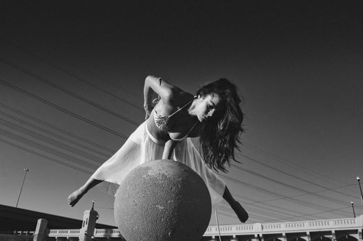 Black and White Photo of Woman Making Complicated Gymnastic Figure 