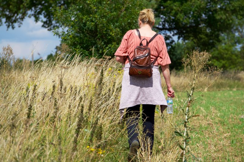 person walking without a phone in hand, hands in pockets