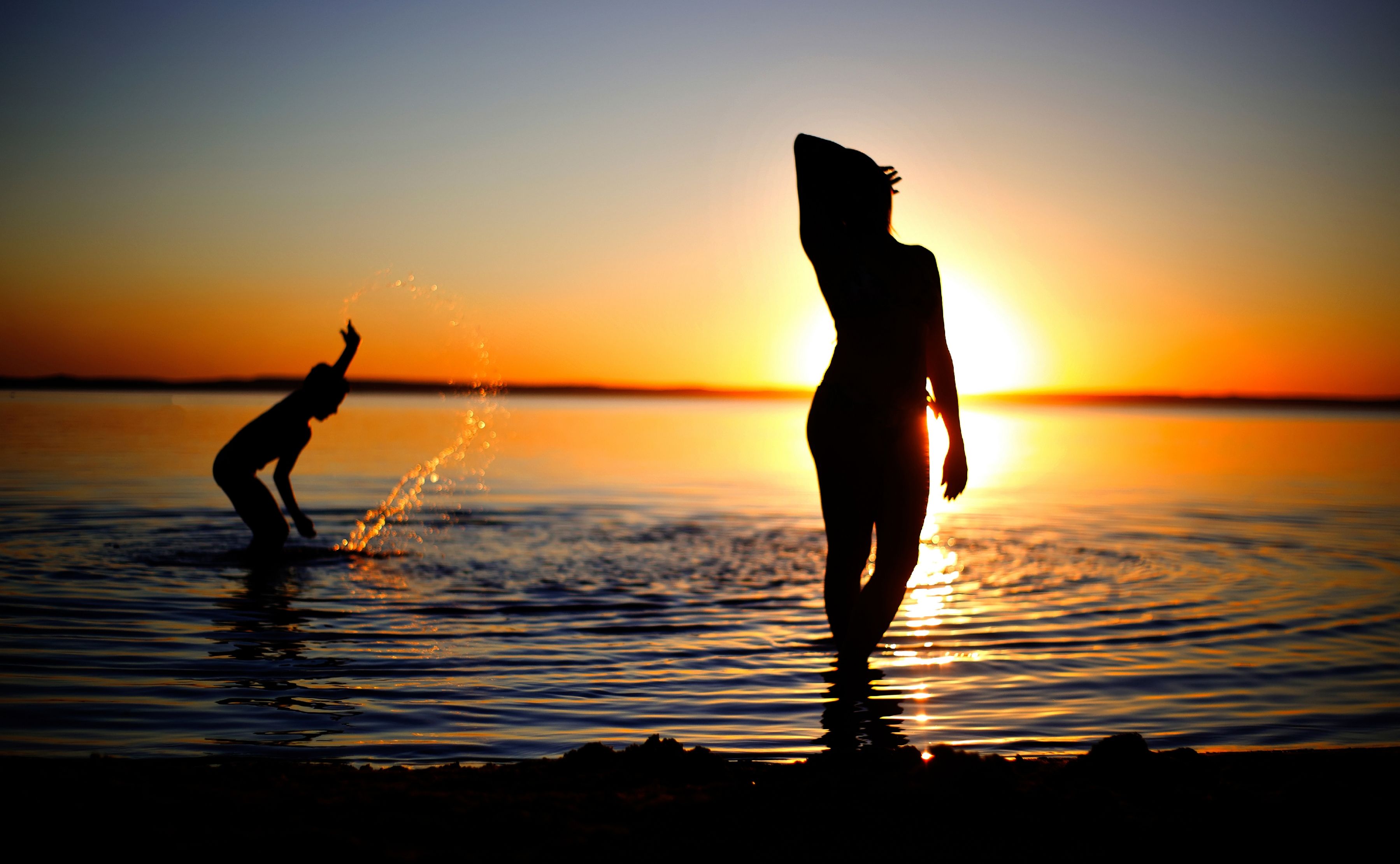 Silhouette of Two People on the Beach during Sunset · Free Stock Photo