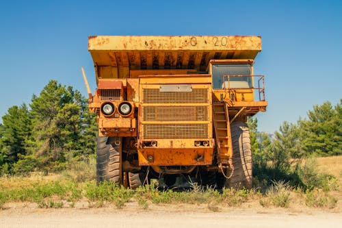 Rusty tipper truck on field in countryside