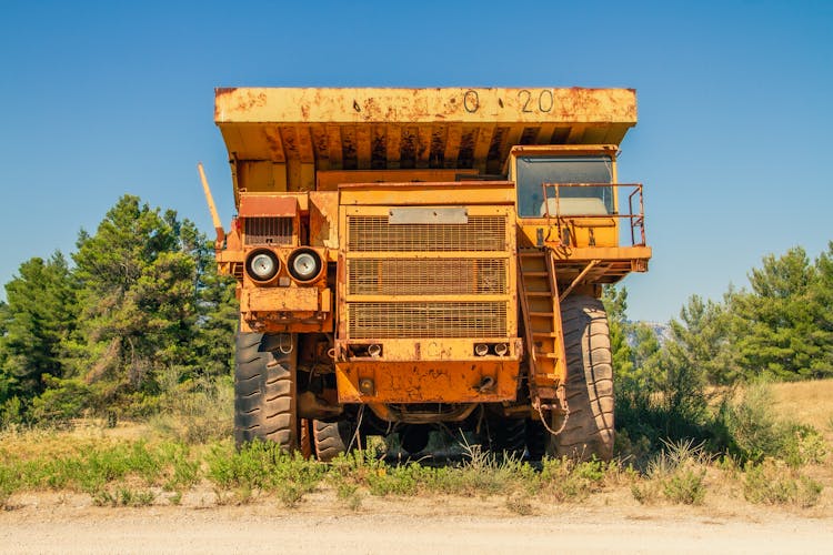 Rusty Tipper Truck On Field In Countryside