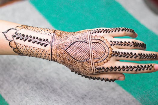 Close-up of a hand adorned with a detailed mehndi design, showcasing cultural art.