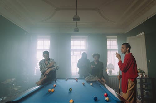 Man in White Dress Shirt Standing Beside Pool Table