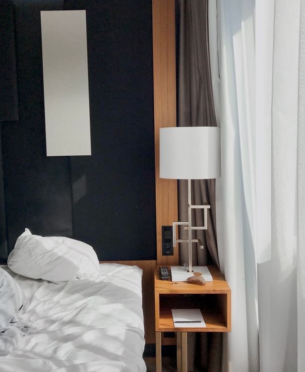 A bedroom with layered lighting and cozy ambiance