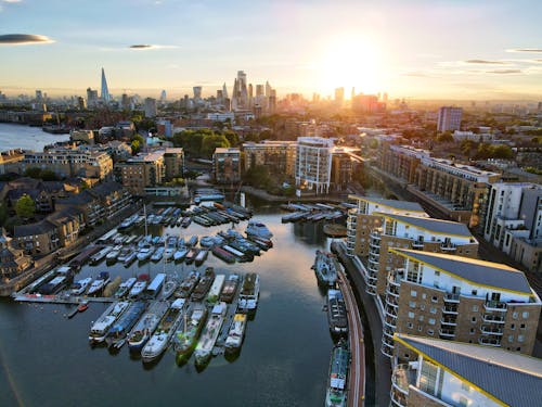 Aerial View of City Buildings and Boats on Water