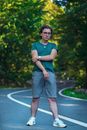 Man in Green Nike Tank Top and Gray Shorts Standing on Track Field