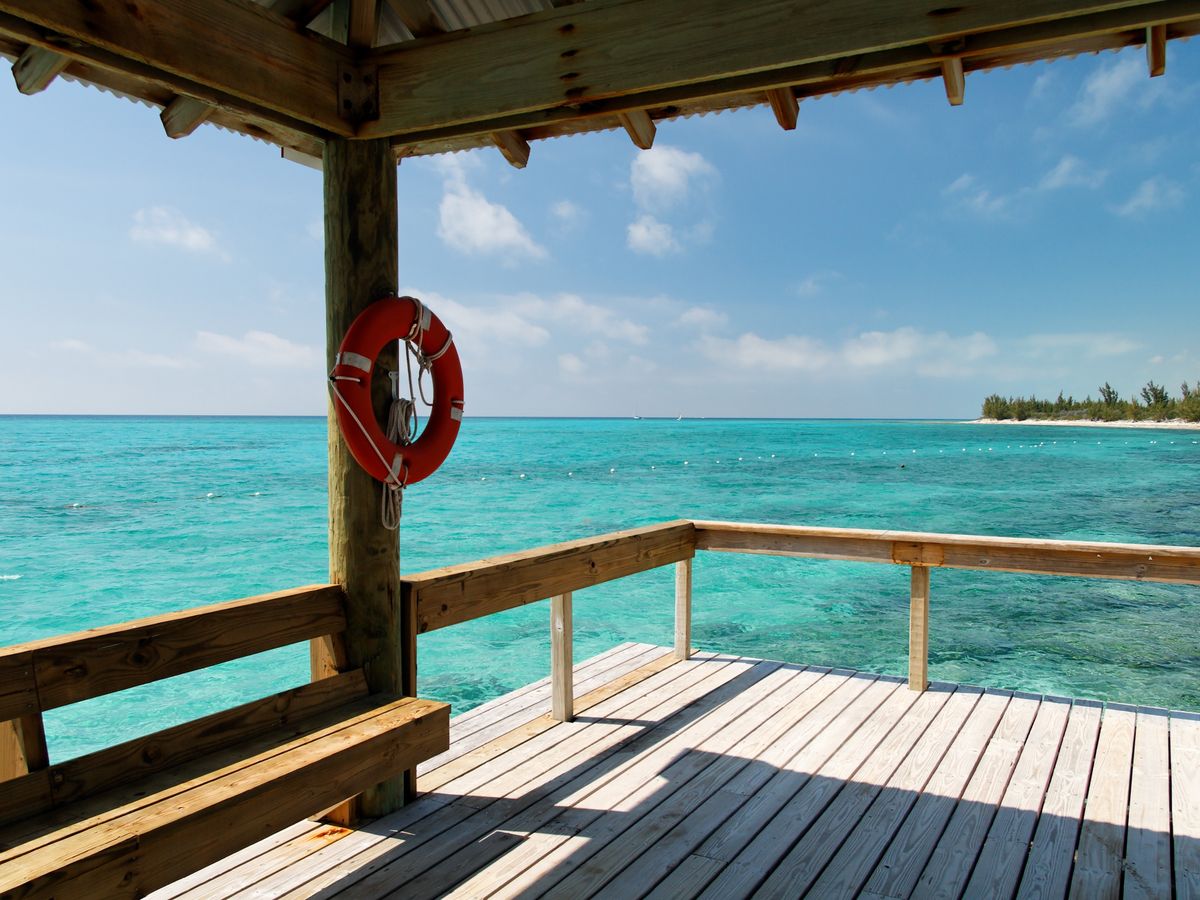 A simple wooden dock extending into clear turquoise water