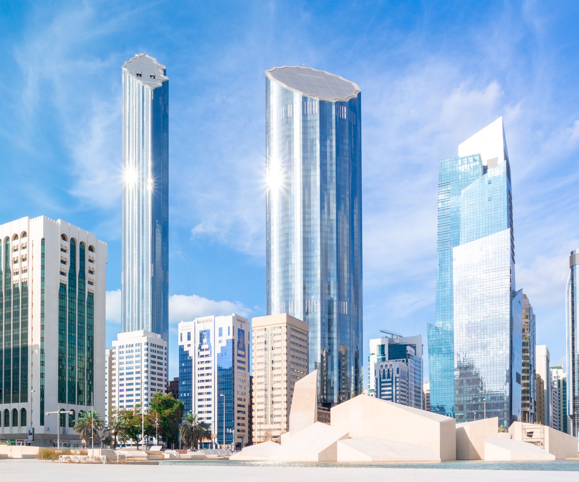 Vibrant view of Abu Dhabi skyline featuring modern skyscrapers under clear blue sky.