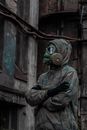 Man in Green and Brown Camouflage Jacket Wearing Gas Mask