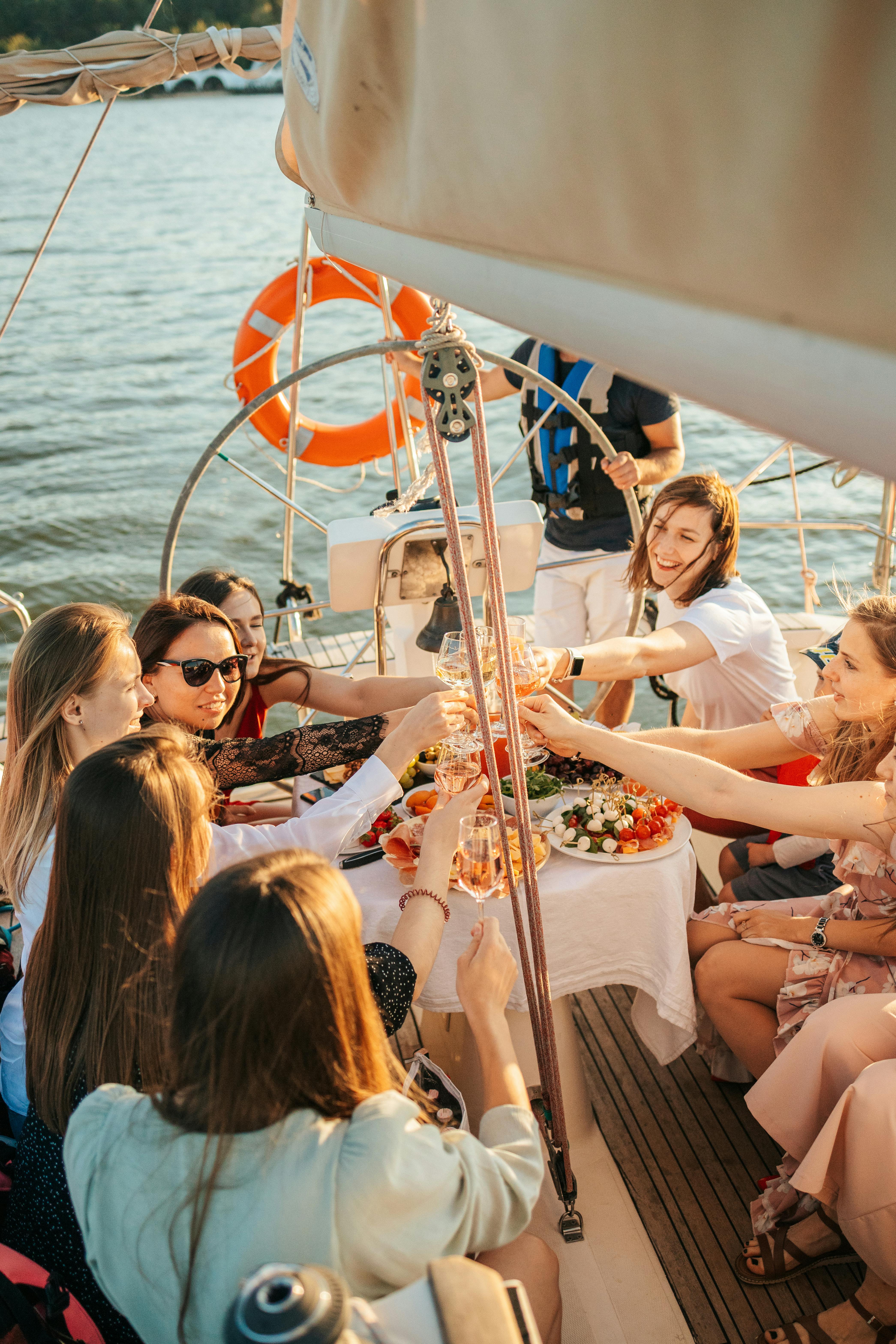 a group of people riding on boat while toasting drinks