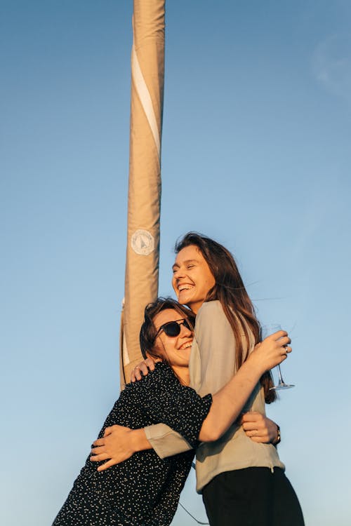 A Low Angle Shot of Women Having Fun while Hugging Each Other