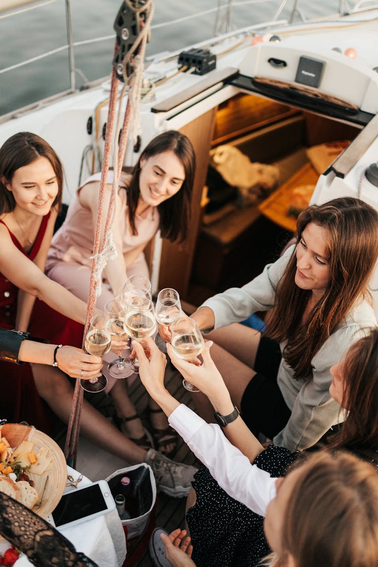 Group Of Women On Yacht Drinking  