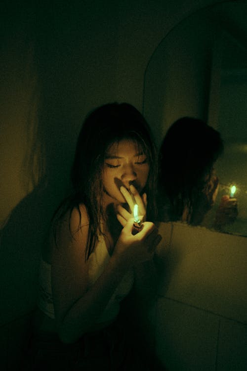 Free A Woman Smoking in the Dark Stock Photo