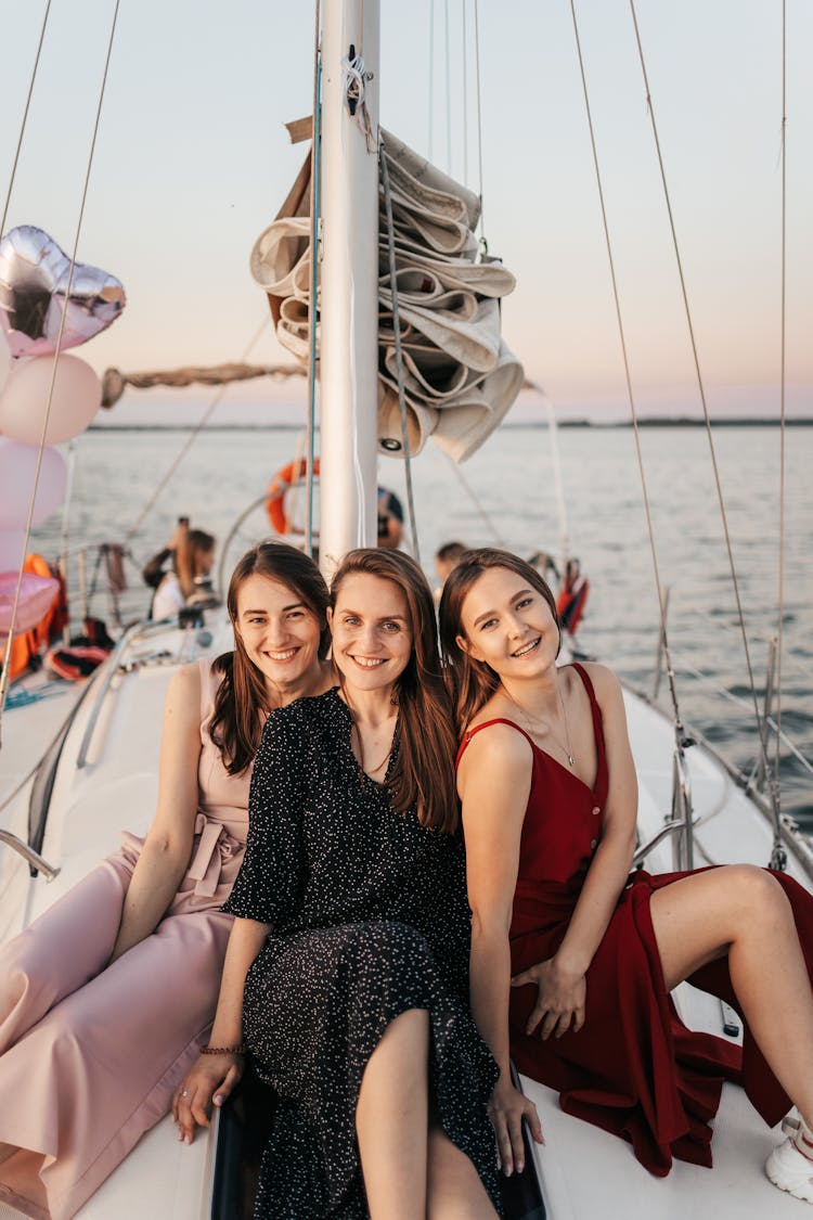 Three Girls Sitting On White Boat