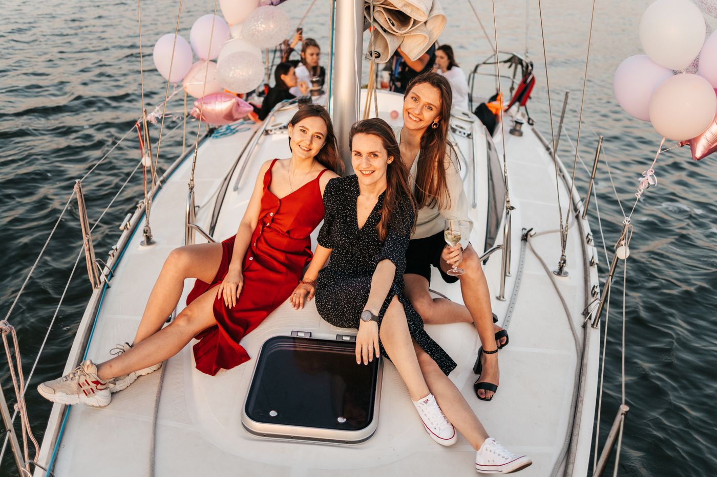 Guests celebrating on a yacht deck at golden hour