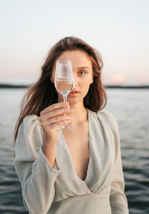 Woman Holding Clear Champagne Glass