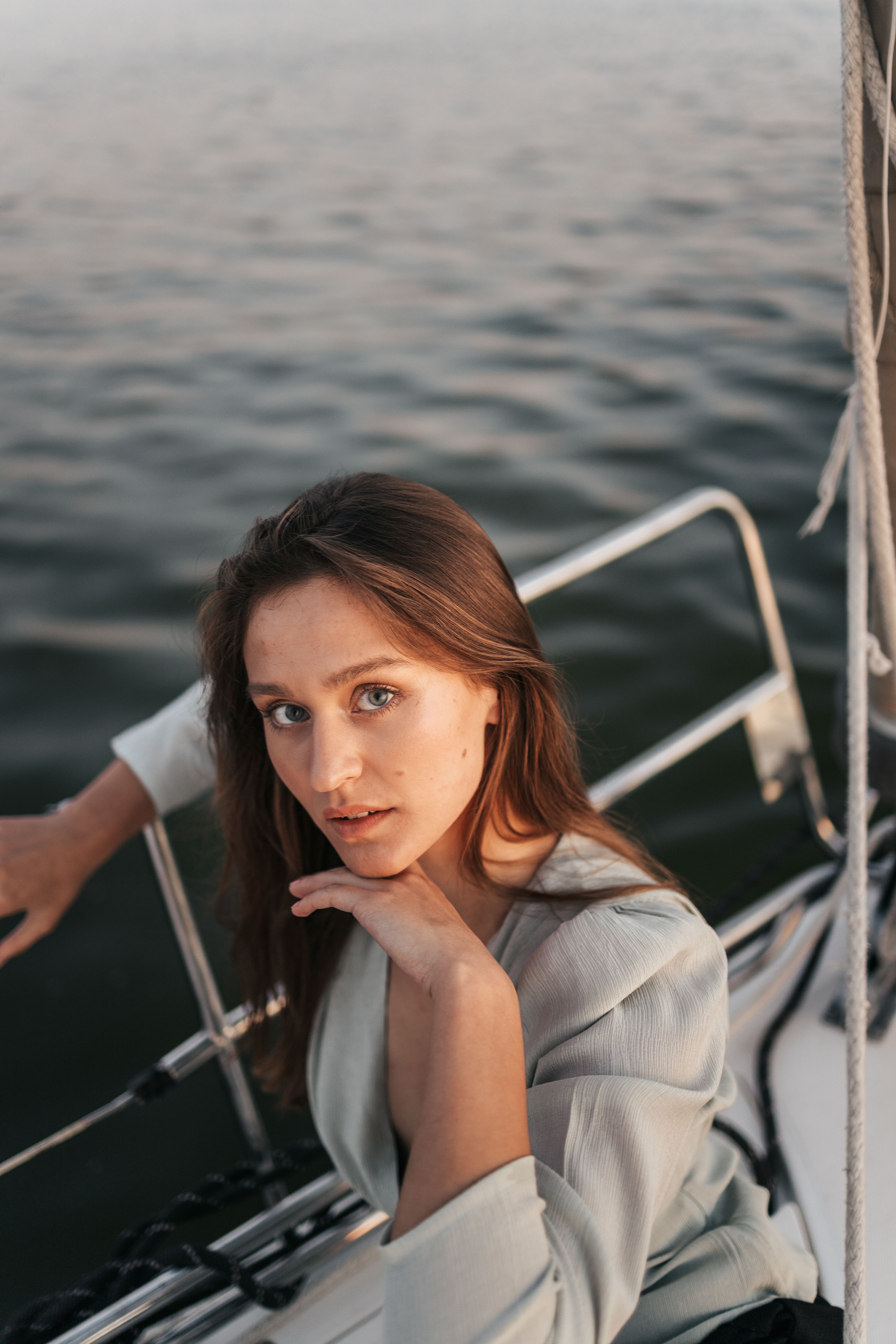 Guest posing on the bow of a yacht at sea