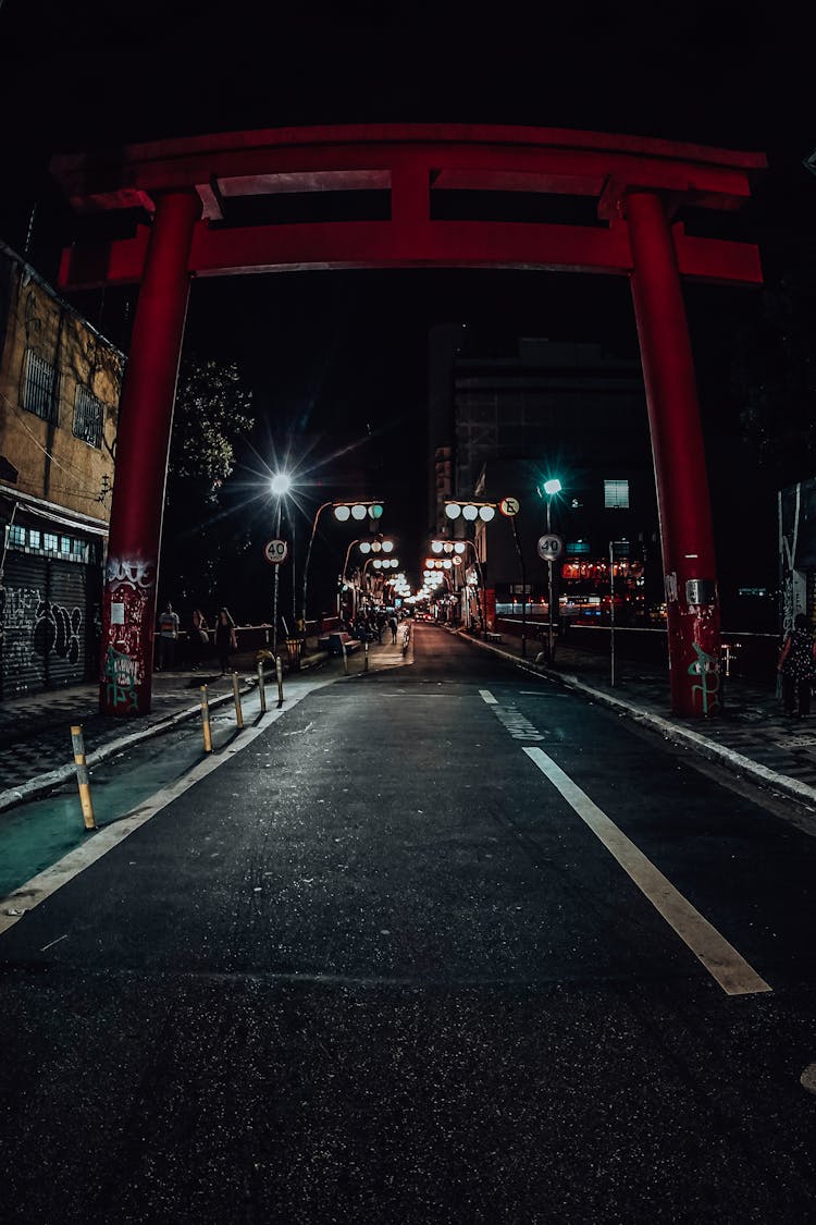 Empty City Road With Shiny Lamp Posts At Night