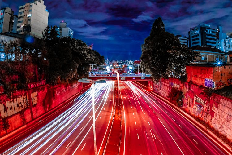 Colorful City Road Between Modern Building Facades At Night