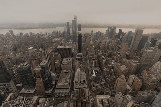 Aerial view of Manhattan's skyscrapers and urban layout during twilight, showcasing the iconic city skyline.