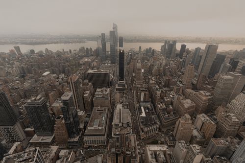 Free Aerial view of Manhattan's skyscrapers and urban layout during twilight, showcasing the iconic city skyline. Stock Photo
