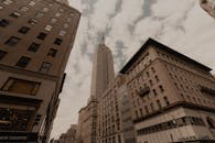 Brown Concrete Building Under White Clouds