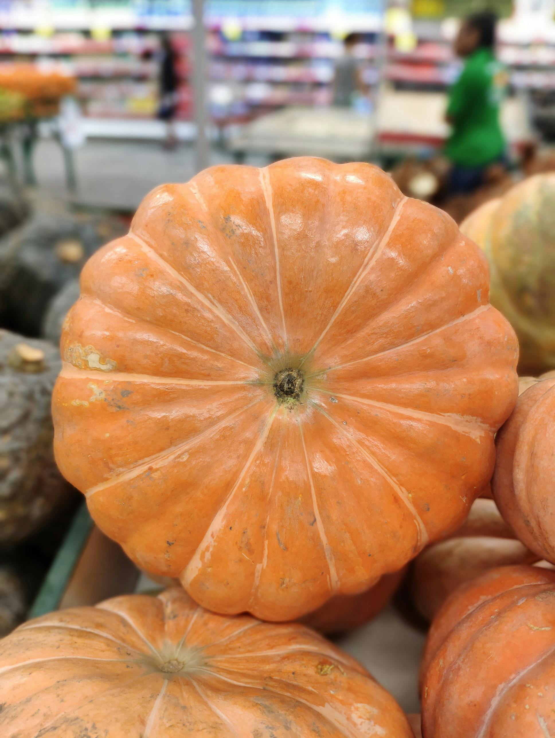 pile of bright ripe pumpkins in grocery store