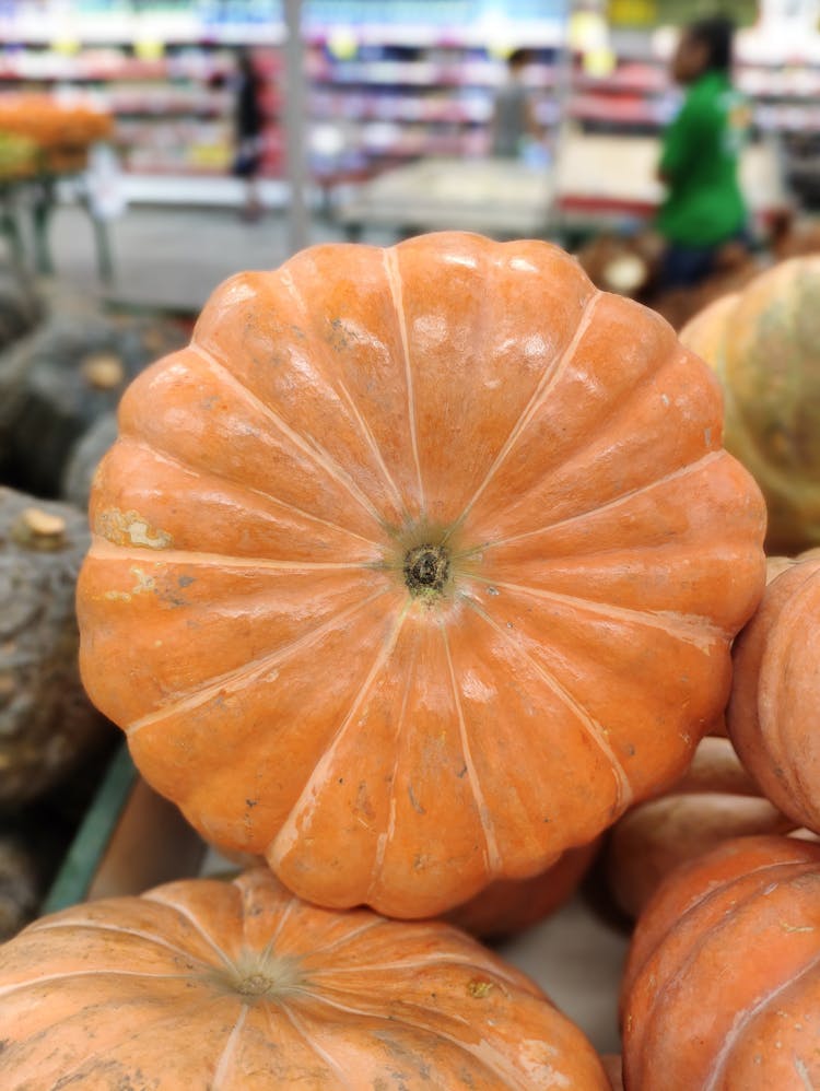 Pile Of Bright Ripe Pumpkins In Grocery Store