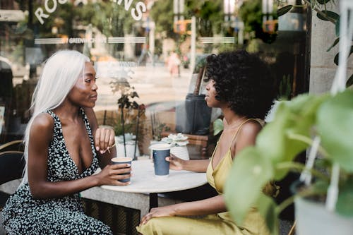 Free Women Having a Conversation at the Coffee Shop Stock Photo