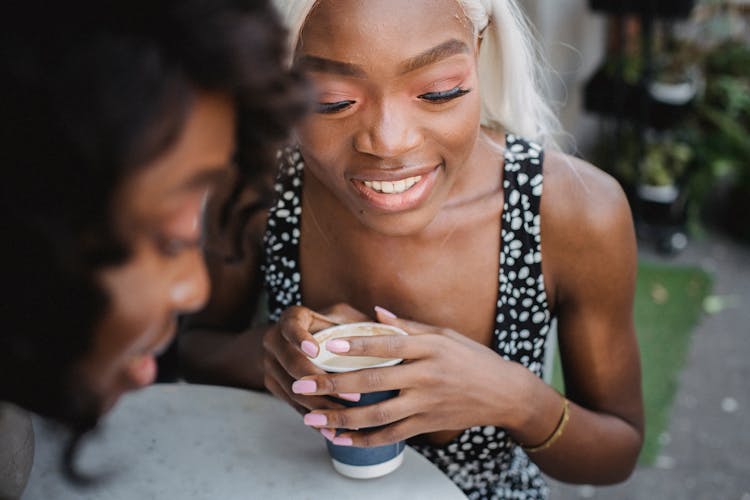 Beautiful Women Friends Drinking Coffee Together 